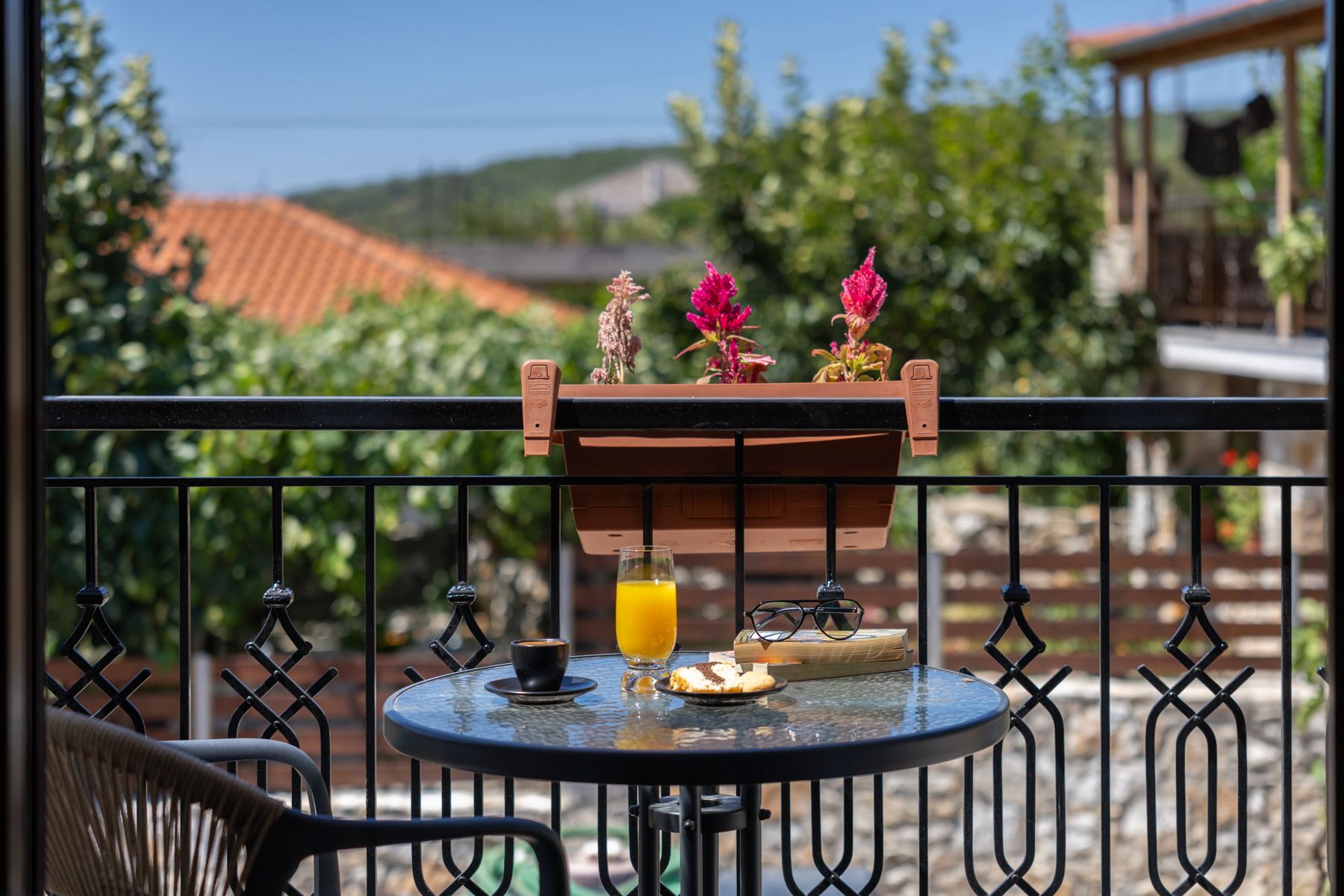 Juice and pastries on Asteroessa's balcony, looking over the village roofs