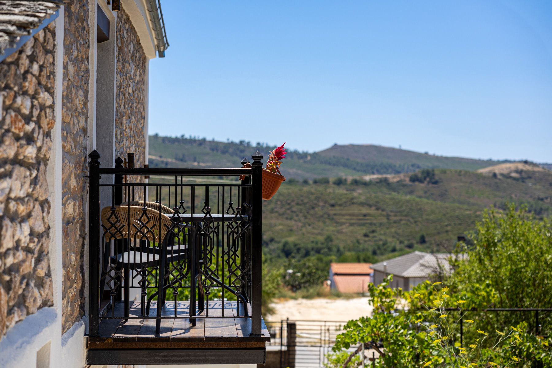 The balcony corner in daylight, looking across to the hills